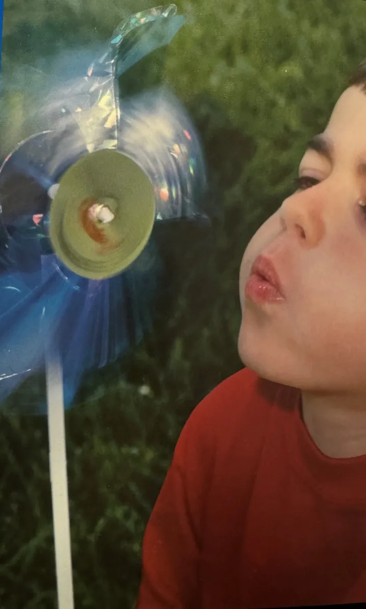 Alex Porta blowing a pinwheel with his new lungs, 1999