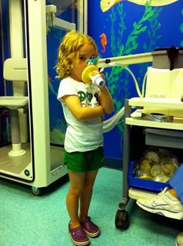 Child performing a spirometry test